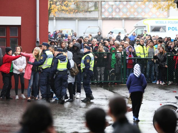 Swedish police officers give information to people as they secured the area outside a primary and middle school in Trollhattan, southwestern Sweden, on October 22, 2015, where a masked man armed with a sword injured an adult and four students before being arrested by police. AFP PHOTO / TT NEWS AGENCY / BJORN LARSSON ROSVALL +++ SWEDEN OUTBJORN LARSSON ROSVALL/AFP/Getty Images